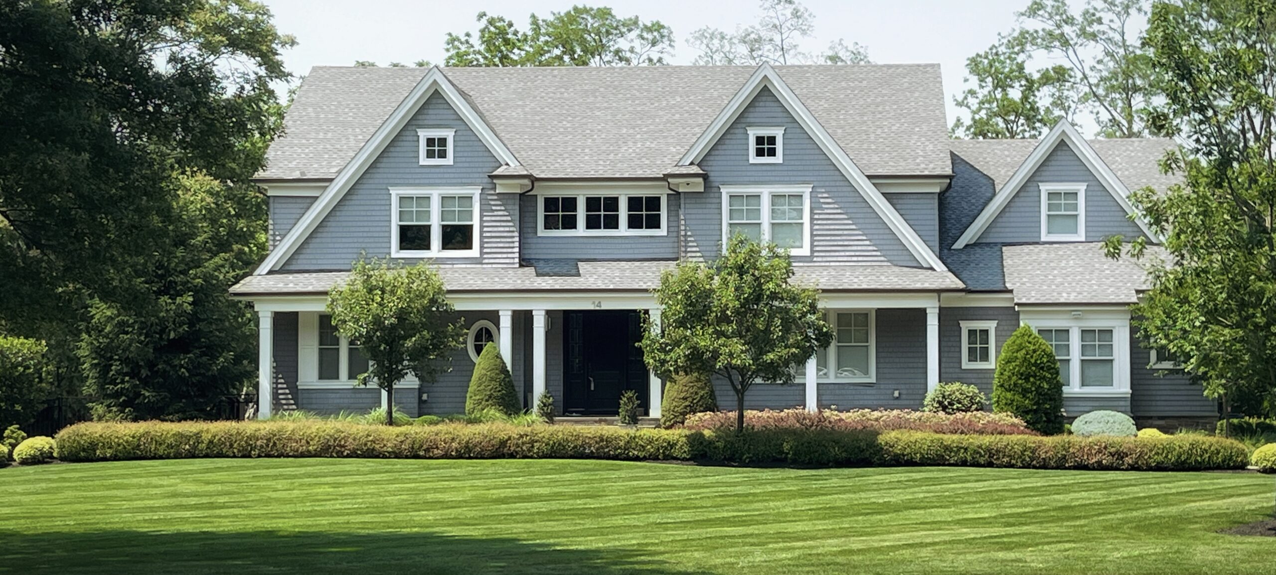 Residential home with professionally landscaped lawn and garden beds in Monmouth County, NJ