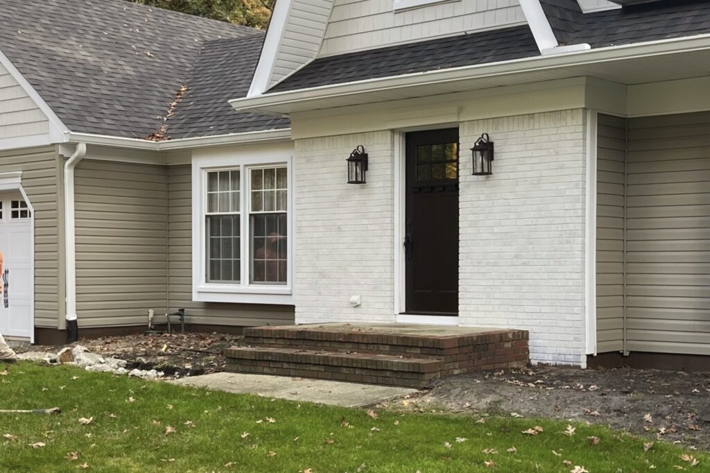 Front entry steps before natural stone hardscape installation