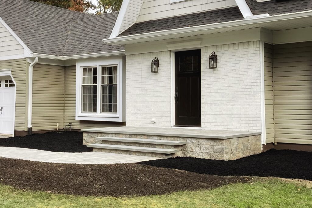 Custom natural stone front steps and entryway after hardscape installation